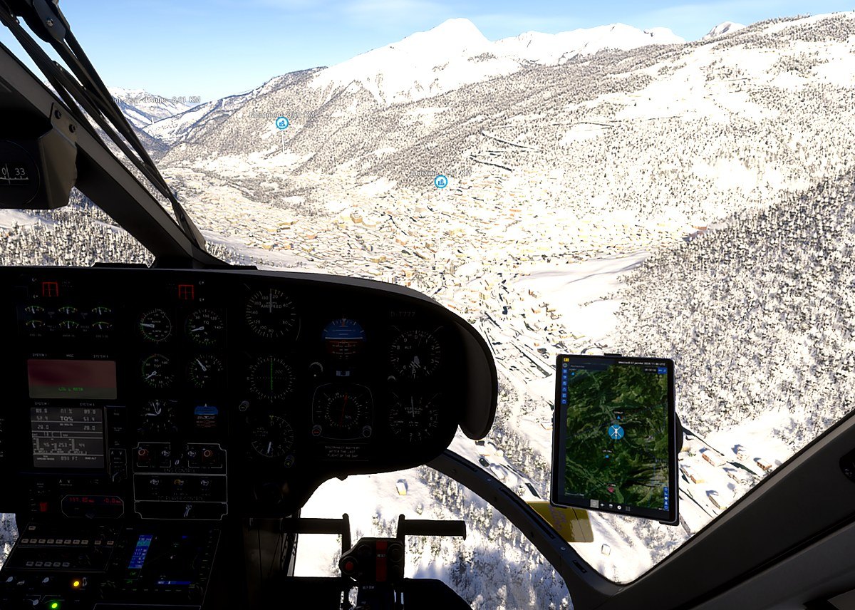 Vue du poste de pilotage au-dessus d’une vallée enneigée, sur le simulateur de vol hélicoptère HélicoSimu